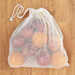 A Slice of Green Large Organic Cotton Net Produce Bag Filled With Fruit With Drawstring Closed