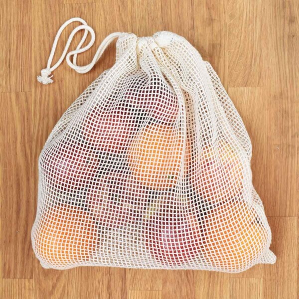 A Slice of Green Large Organic Cotton Net Produce Bag Filled With Fruit With Drawstring Closed