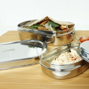 A Slice of Green Stainless Steel Oval Lunch Box with Mini Container Both Open With Food Inside