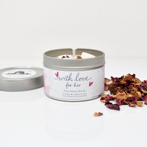 Pink Peony Blush soy wax candle in an open silver tin with dried petals and a heart-patterned white label.